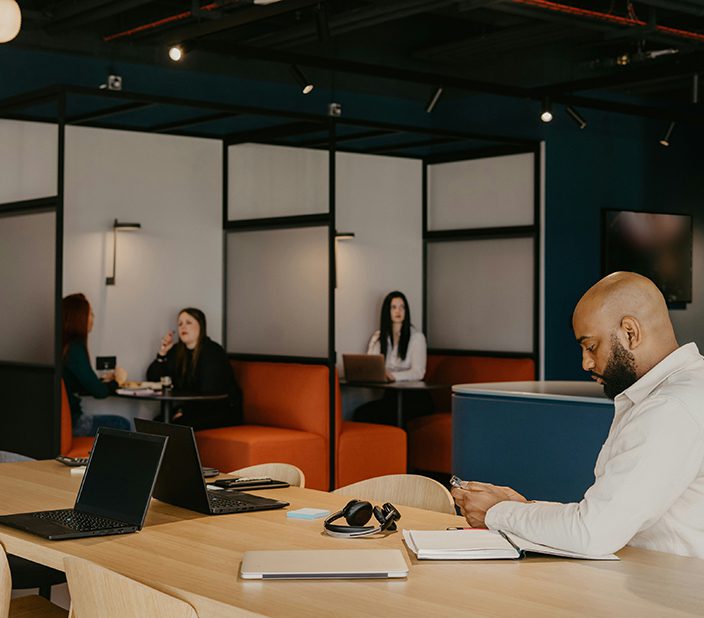Co-working space with booths and tables.