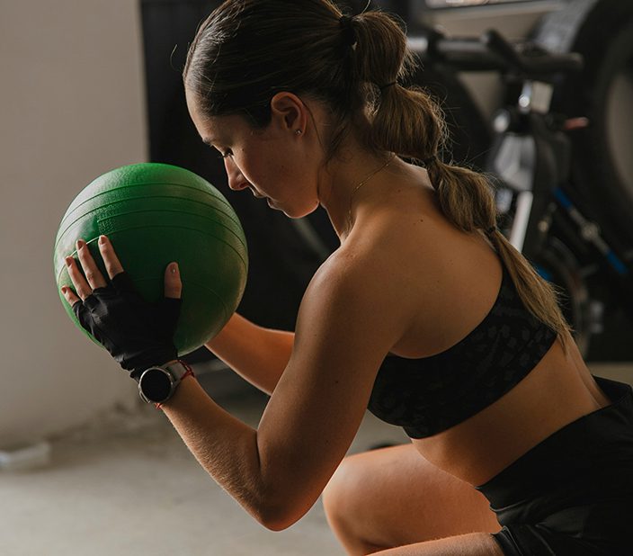 Person exercising with medicine ball.