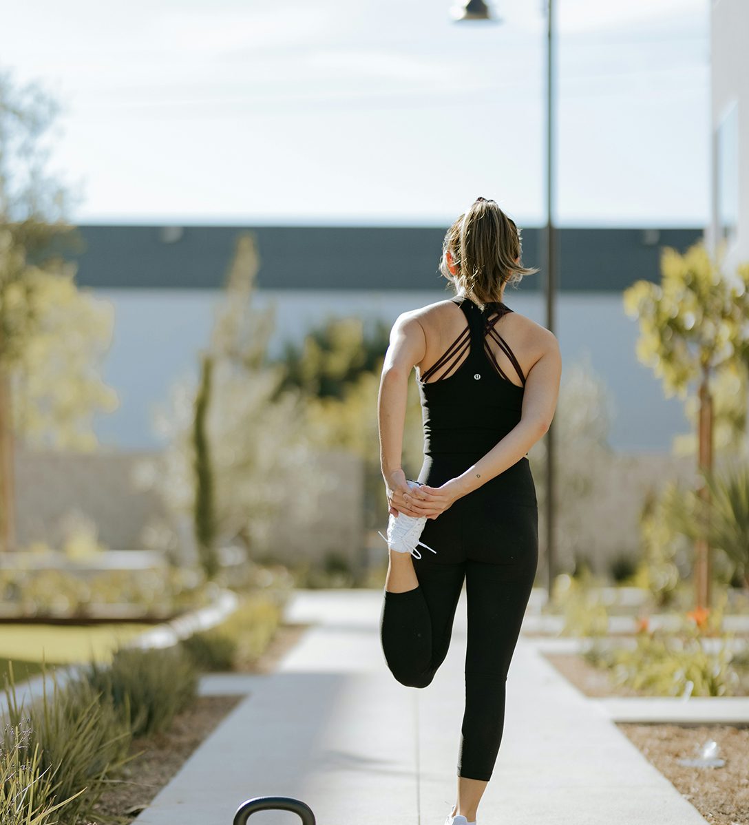 Person stretching their legs during morning run.