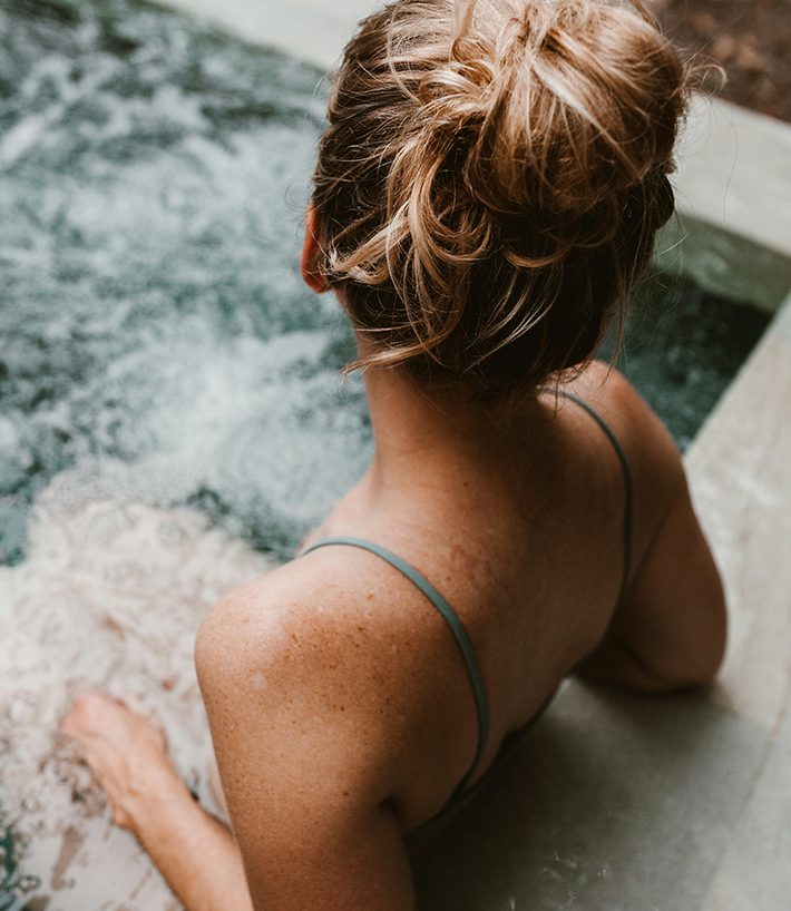 Person relaxing in hot tub.