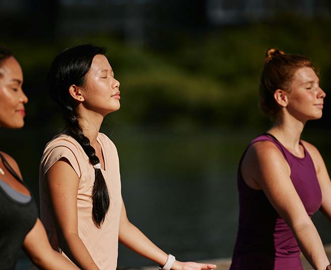 People meditating outside.