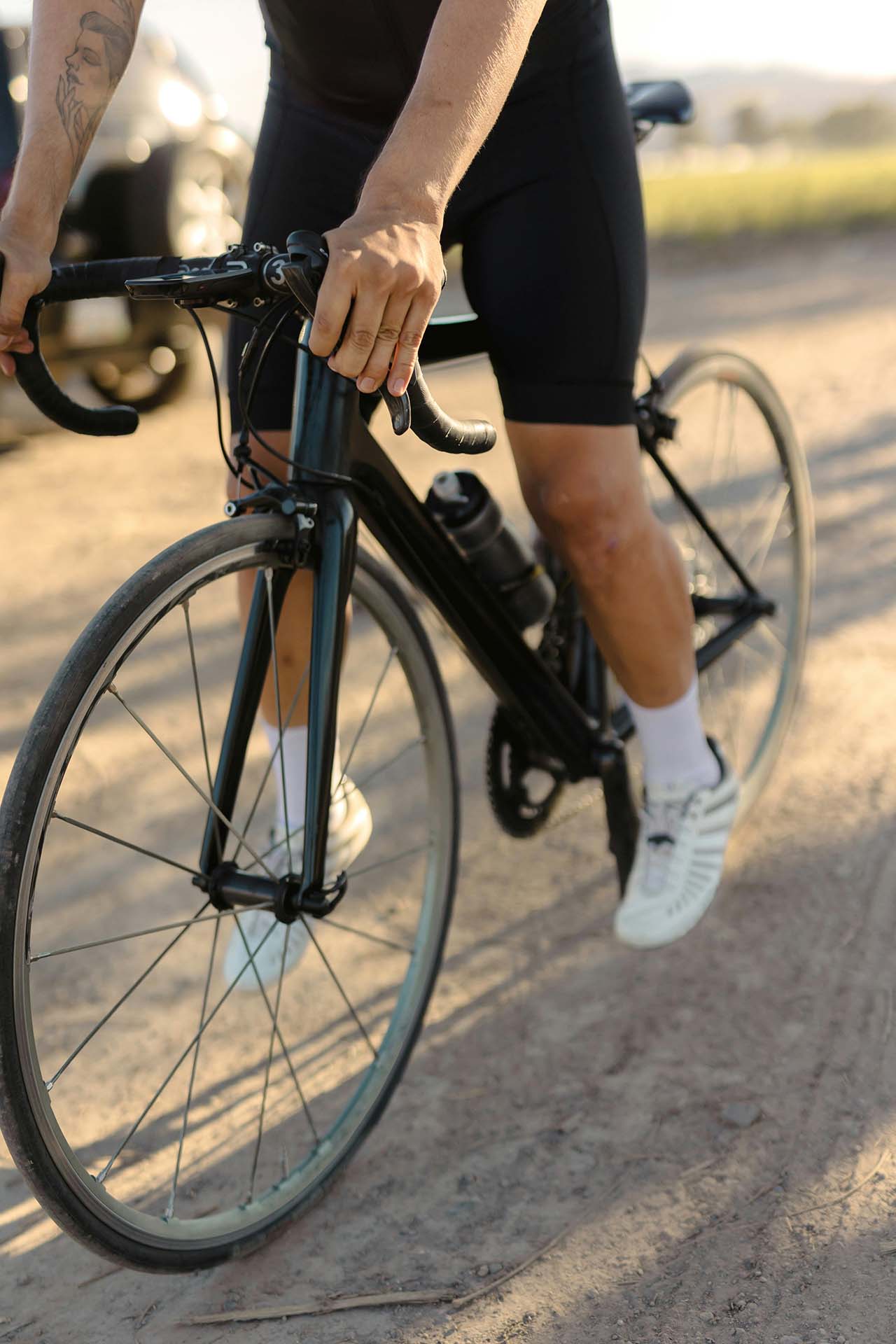 Person riding bike in the sunshine.